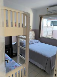 a bedroom with a bunk bed next to a window at CASA FAMILIAR “SANTA PAZ” in Aparecida