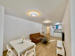 a living room with a table and a couch at BAJ - Apartamentos en Playa Bajondillo, Torremolinos in Torremolinos +19 photos