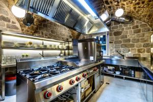 a large kitchen with a large stove top oven at Luxury Dubrovnik Villa 6 Bedrooms Villa Gomila Perfect For Larger Groups in Zaton