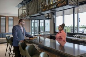 a man and a woman standing at a bar at Fairfield by Marriott Inn & Suites Sikeston in Sikeston +34 photos