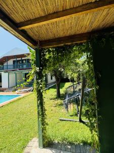a pergola covered in ivy next to a pool at Sapanca Bizim Konak in Sapanca