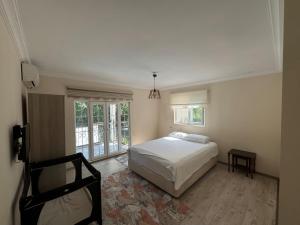 a bedroom with a white bed and a window at Sapanca Bizim Konak in Sapanca +23 photos