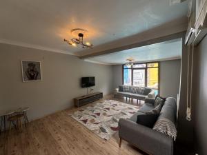 a living room with a couch and a television at Sapanca Bizim Konak in Sapanca