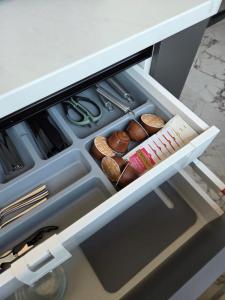 an open drawer of a refrigerator with some donuts at Coquette Appart in Eforie
