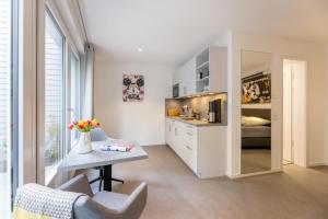 a living room with a table and a bedroom at Haus-Andersen-Ferienwohnung-2 in Norderney