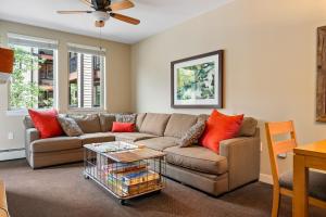 a living room with a couch and a table at Fraser Crossing cabin in Winter Park