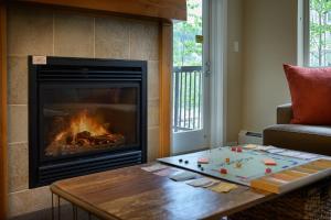 a living room with a fireplace and a coffee table at Fraser Crossing cabin in Winter Park +21 photos