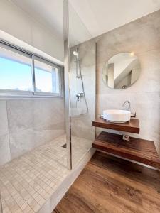 a bathroom with a sink and a mirror at L’adresse rêvée Balcon vue mer in Ploemeur