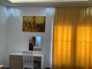 a room with a yellow curtain and a mirror at Aberdeen Richview Luxury Apartments Full 1 Bedroom Apartment Sleeps 3 A200 in Freetown