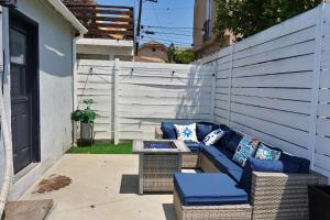 a blue couch sitting on the side of a building at Casa Mid City - Centrally Located 1BR Getaway with Private Yard in Los Angeles