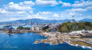 a view of a city and the ocean with buildings at Sokcho Travel Hotel in Sokcho