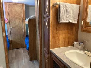 a bathroom with a sink and a mirror and a sink at The Princeton at New Frontiers Retreat in Eganville