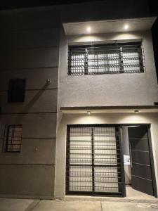 a building with a gate on the side of it at Duplex premium in La Porteña +4 photos