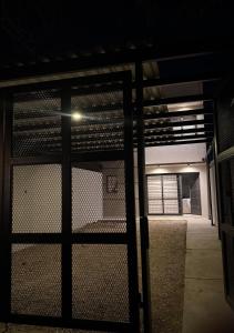 an open gate in a building with a fence at Duplex premium in La Porteña