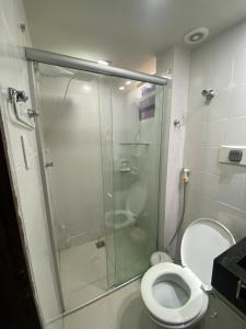 a bathroom with a glass shower with a toilet at Pousada Atlântico tambaú praia in João Pessoa +35 photos