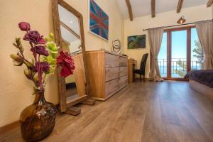a living room with a vase with flowers in it at Astounding Hvar Villa 4 Bedrooms Villa Crystal Hvar 1 Mesmerizing Sea Views & Private Infinity Pool in Hvar