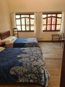 Ένα ή περισσότερα κρεβάτια σε δωμάτιο στο Hotel Las Violetas