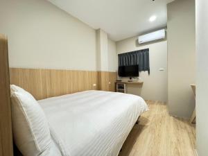 Ліжко або ліжка в номері Yoshi Hotel Xinmei Street