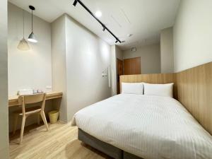 Ліжко або ліжка в номері Yoshi Hotel Xinmei Street