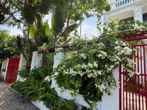 une clôture blanche avec un bouquet de fleurs dessus dans l'établissement The Paddys Home, à Hiếu Nhơn