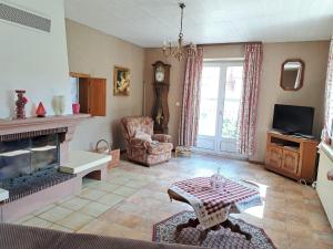 a living room with a fireplace and a tv at Holiday Home in Reipertswiller near Castle in Reipertswiller