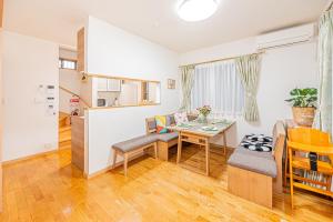 a living room with a table and a dining room at Anzu 4 Bed rooms Villa 5 minutes walk from Keise line Edogawa station in Tokyo