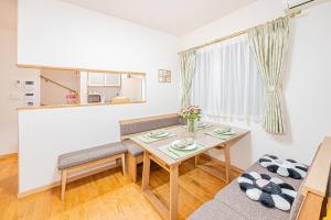 a living room with a table and a couch at Anzu 4 Bed rooms Villa 5 minutes walk from Keise line Edogawa station in Tokyo +79 photos