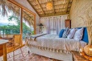 a bedroom with a bed and a balcony at NEW! Jacuzzi, lake-access luxury in San Marcos La Laguna