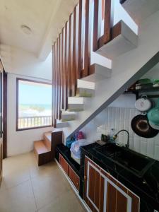 a kitchen with a spiral staircase in a house at Slili View Villa in Tepus