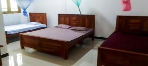 a bedroom with two beds in a room at Igloo Tourist Homestay Anuradhapura in Anuradhapura