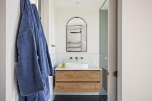a bathroom with a sink and a mirror at Chalet Coast Walburra Brook in Metricup +10 photos