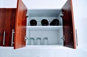 a cupboard with some cups in it at Casa SUR in Colonia de Venado