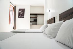 Postel nebo postele na pokoji v ubytování Toucan Platinum Suites Aparthotel