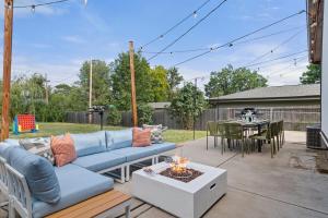 a patio with a blue couch and a table at Cozy 5BR - Outdoor Theater, Fire Pit, Games in Westminster