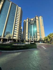 two tall buildings in a city with a parking lot at Flat 805 - Av. Ibirapuera, Moema in São Paulo