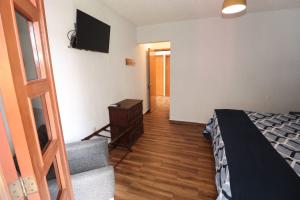 a bedroom with a bed and a television on the wall at Hotel Casa Frida in Cuernavaca