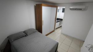 a small bedroom with a bed and a kitchen at Apartamento Varandinha Mar Ponta Negra 2 Quartos para 4 pessoas in Natal +42 photos