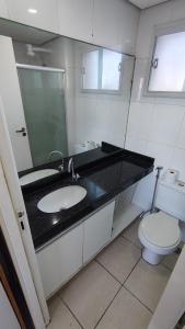 a bathroom with a sink and a toilet at Apartamento Varandinha Mar Ponta Negra 2 Quartos para 4 pessoas in Natal