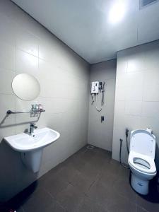 a bathroom with a white toilet and a sink at Cozy Homes at i-City WiFi TV Box and 1 Carpark in Shah Alam