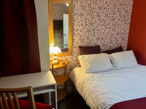 a small bedroom with a bed and a mirror at Room at Sandon road in Birmingham