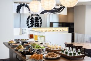 a buffet with food and drinks on a table at Via Inn Shin Osaka in Osaka