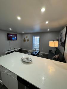 a kitchen and living room with a white counter top at 3 STATE FAIR l DT Dallas l FIFA READY l Staycation 1Bd1Ba in Dallas