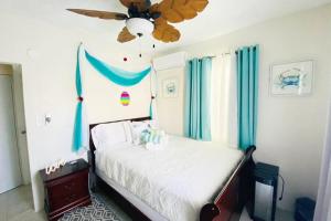 a bedroom with a bed with a ceiling fan at Villa Campo Mar Amazing Pool Beach 7 Minutes Drive in Tierras Nuevas Poniente +47 photos