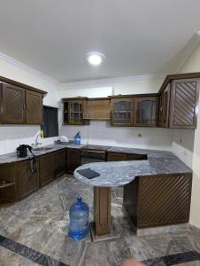 a kitchen with wooden cabinets and a counter top at Holiday inn in Islamabad