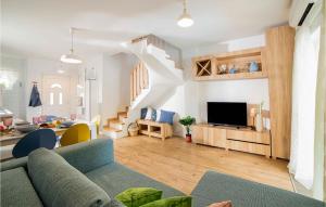 a living room with a couch and a tv at Cozy Home In Klimno With Wifi in Klimno