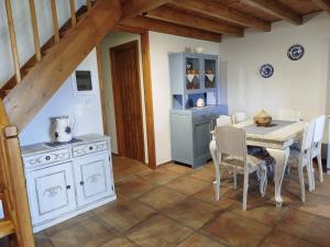 a kitchen with a white table and a table and chairs at dilemi 3 in Tavari +20 photos