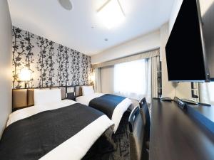 Телевизор и/или развлекательный центр в APA Hotel Tennoji Ekimae