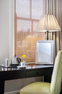 a desk with a laptop computer and a lamp on it at Quarters Hotel in Durban