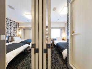 Кровать или кровати в номере APA Hotel Tennoji Ekimae +37 фотографий
