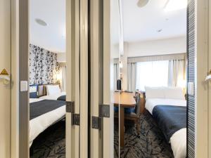 Кровать или кровати в номере APA Hotel Tennoji Ekimae